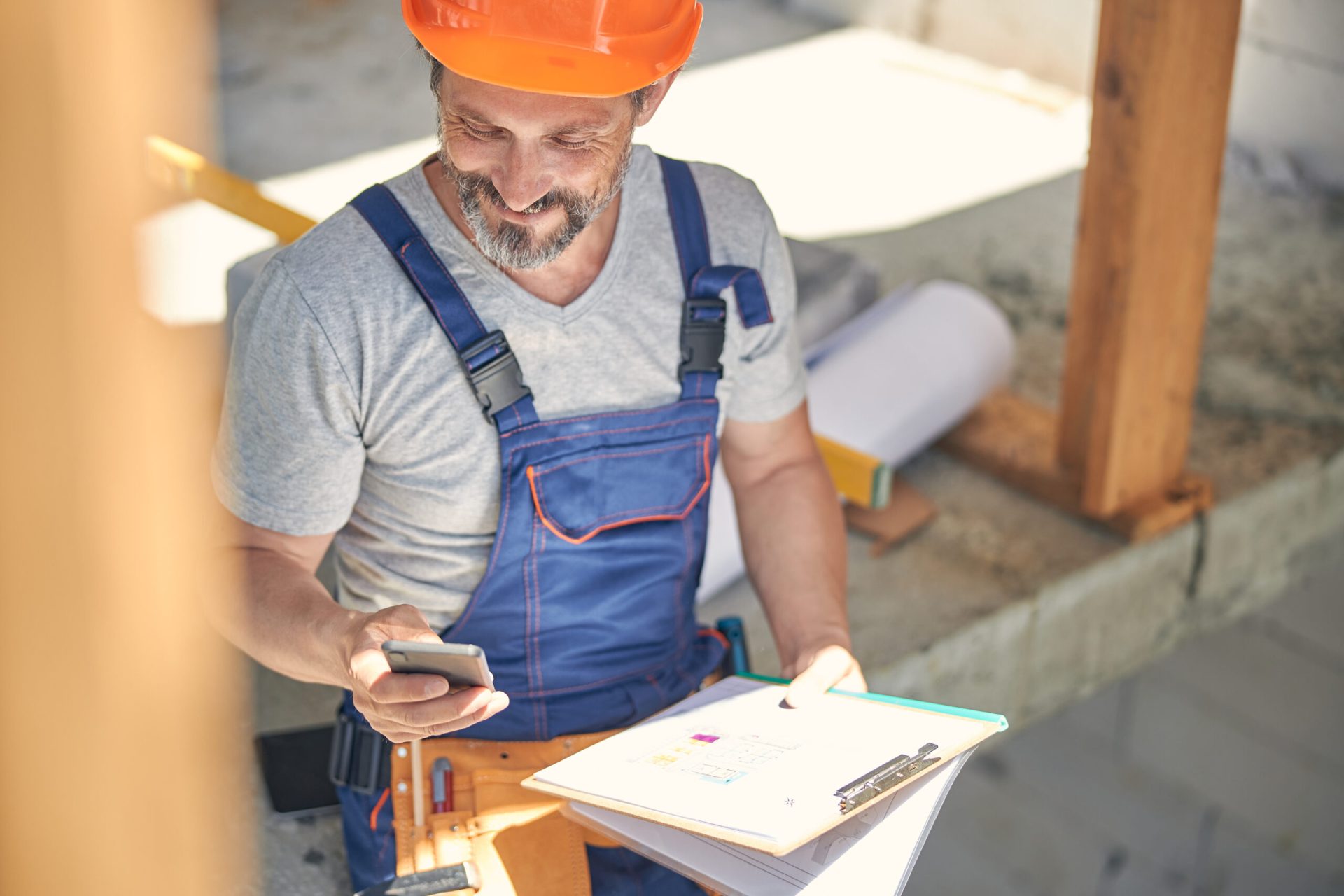 pleased male worker reading a text message