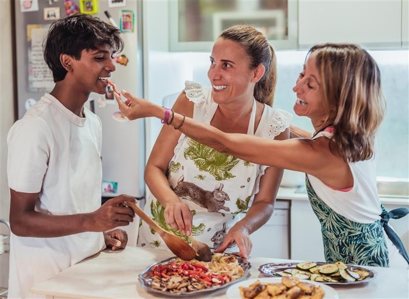 Family cooking dinner in a kitchen