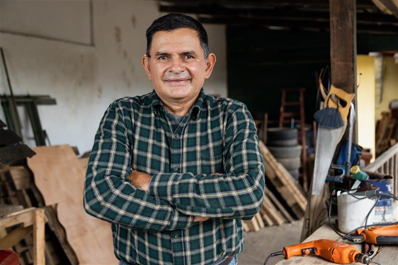 An owner builder standing in a home being built